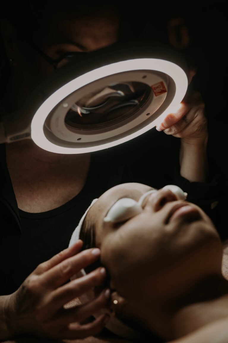 Kerry analyzing a clients skin a custom skincare plan for her client