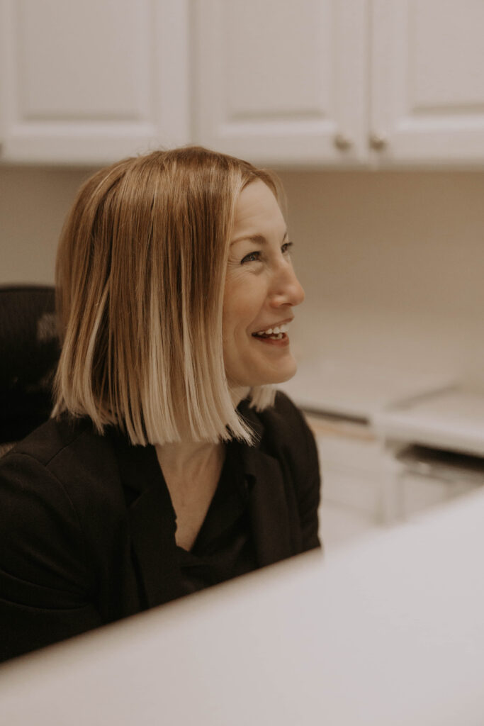 receptinist smiling at a client being greeted at the spa setting